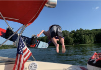 Jumping into lake from 2004 Rinker Captiva 232